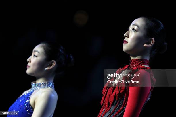 Mao Asada of Japan and Yu-Na Kim of Korea look on from the podium after winning the Ladies Free Skate during the 2010 ISU World Figure Skating...