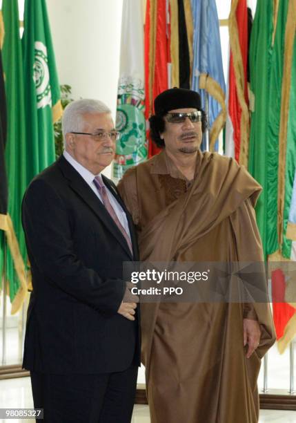In this handout image supplied by the Palestinian Press Office , Palestinian President Mahmoud Abbas greets Libyan leader Muammar Gaddafi on the...