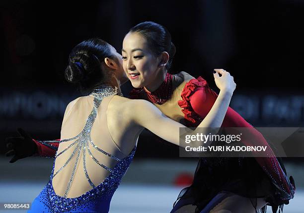 Silver medalist South Korea's Yu-Na Kim congratulates gold medalist Japan's Mao Asada on the podium of the Ladies' competition at the World Figure...