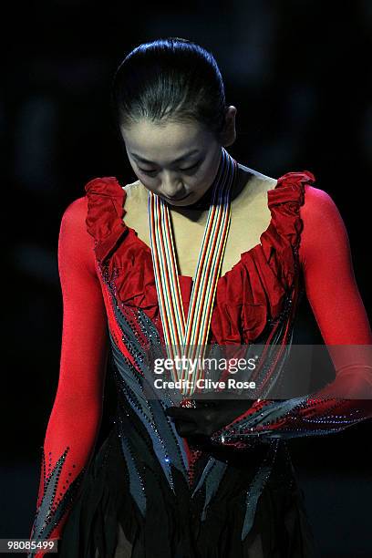 Mao Asada of Japan looks at her Gold medal on the podium after winning the Ladies Free Skate during the 2010 ISU World Figure Skating Championships...