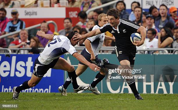 Kurt Baker of New Zealand moves the ball up against Lee Jones of Scotland on day two of the IRB Hong Kong Sevens on March 27, 2010 in Hong Kong.