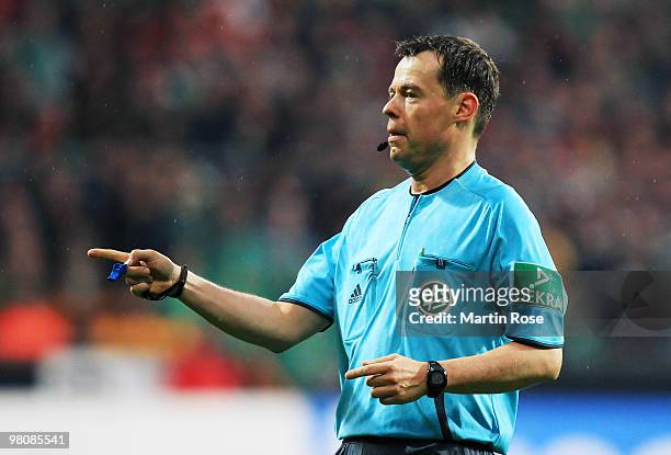 Referee Markus Schmidt makes a point during the Bundesliga match between Werder Bremen and 1. FC Nuernberg at the Weser Stadium on March 27, 2010 in...