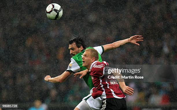Hugo Almeida of Bremen and Andreas Wolf of Nuernberg jump for a header during the Bundesliga match between Werder Bremen and 1. FC Nuernberg at the...