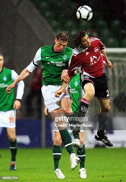 Tim Borowski of Bremen and Thomas Broich of Nuernberg jump for a header during the Bundesliga match between Werder Bremen and 1. FC Nuernberg at the...