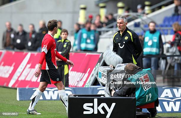 Hanno Balitsch of Hannover leaves the pitch after receiving the second yellow card next to head coach Mirko Slomka during the Bundesliga match...