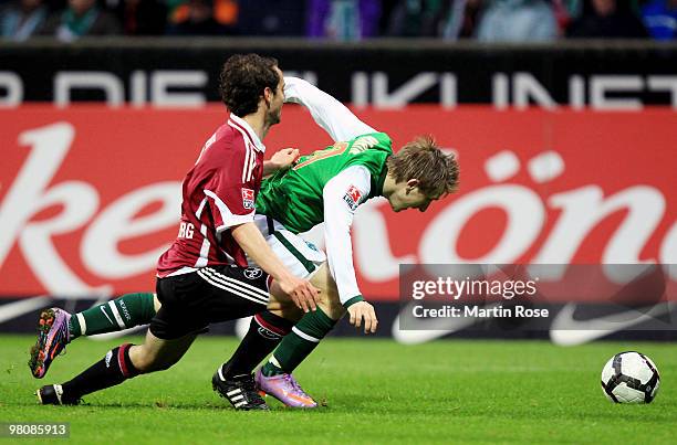 Marko Marin of Bremen and Dominic Maroh of Nuernberg compete for the ball during the Bundesliga match between Werder Bremen and 1. FC Nuernberg at...