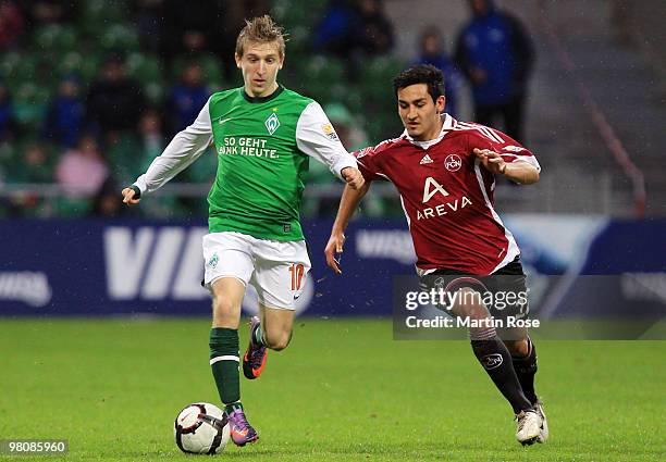 Marko Marin of Bremen and Ilkay Guendogan of Nuernberg compete for the ball during the Bundesliga match between Werder Bremen and 1. FC Nuernberg at...