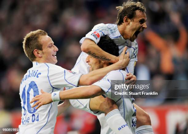 Kevin Kuranyi of Schalke celebrates scoring his team's first goal with team mates Ivan Rakitic and Rafinha during the Bundesliga match between Bayer...