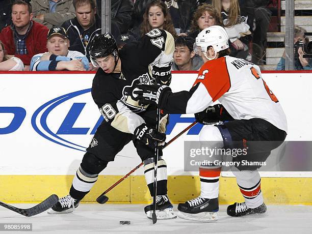 Tyler Kennedy of the Pittsburgh Penguins moves the puck in front of Lukas Krajicek of the Philadelphia Flyers on March 27, 2010 at Mellon Arena in...