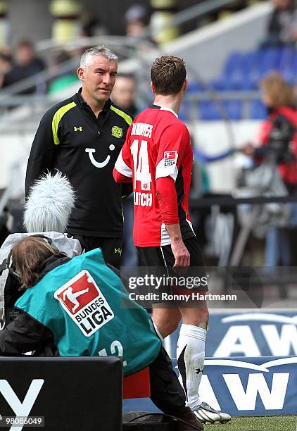 Hanno Balitsch of Hannover leaves the pitch after receiving the second yellow card next to head coach Mirko Slomka during the Bundesliga match...