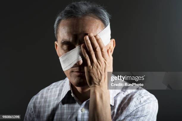 middle aged man head wrapped in bandage - head bandage stock pictures, royalty-free photos & images