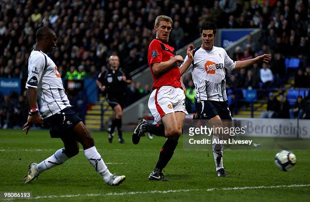 Jlloyd Samuel of Bolton Wanderers scores an own goal during the Barclays Premier League match between Bolton Wanderers and Manchester United at the...