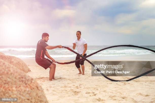 battle ropes on the beach. - battle rope stock pictures, royalty-free photos & images