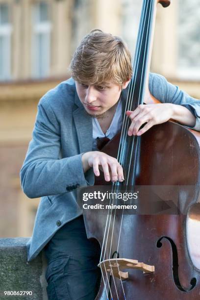 double bass player on the charles bridge in prague - double bass stock pictures, royalty-free photos & images