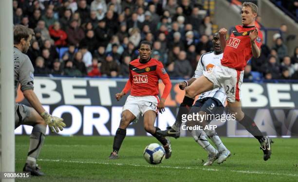 Bolton Wanderers' Trinidad and Tobago defender Jlloyd Samuel scores an own goal during the English Premier League football match between Bolton...