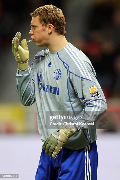 Goalkeeper Manuel Neuer of Schalke spitts during the Bundesliga match between Bayer Leverkusen and FC Schalke 04 at the BayArena on March 27, 2010 in...