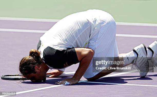 Marcos Baghdatis of Cyprus kisses the court after defeating Juan Ignacio Chela of Argentina during day five of the 2010 Sony Ericsson Open at Crandon...