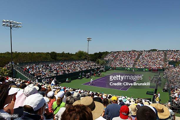 Marcos Baghdatis of Cyprus takes on Juan Ignacio Chela of Argentina during day five of the 2010 Sony Ericsson Open at Crandon Park Tennis Center on...