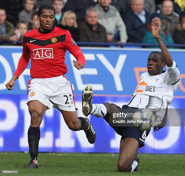 Antonio Valencia of Manchester United clashes with Fabrice Muamba of Bolton Wanderers during the FA Barclays Premier League match between Bolton...