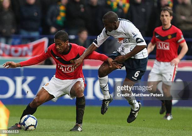 Antonio Valencia of Manchester United clashes with Fabrice Muamba of Bolton Wanderers during the FA Barclays Premier League match between Bolton...