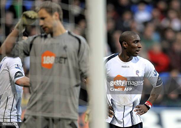 Bolton Wanderers' Trinidad and Tobago defender Jlloyd Samuel and Finnish goalkeeper Jussi Jaaskelainen react after Samuel scores an own goal during...