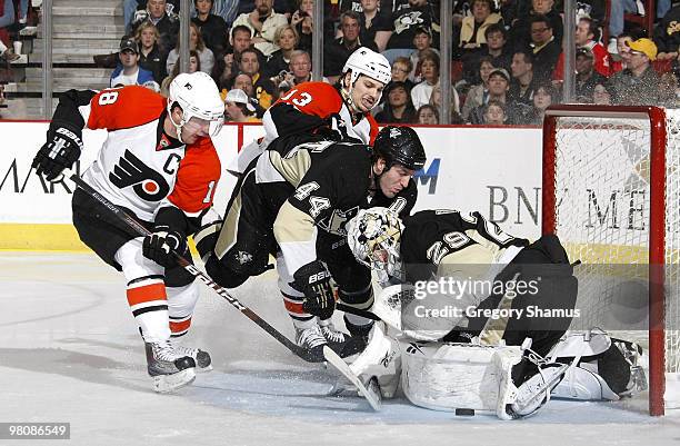 Marc-Andre Fleury and Brooks Orpik reach for the loose puck after a shot by Mike Richards of the Philadelphia Flyers on March 27, 2010 at Mellon...