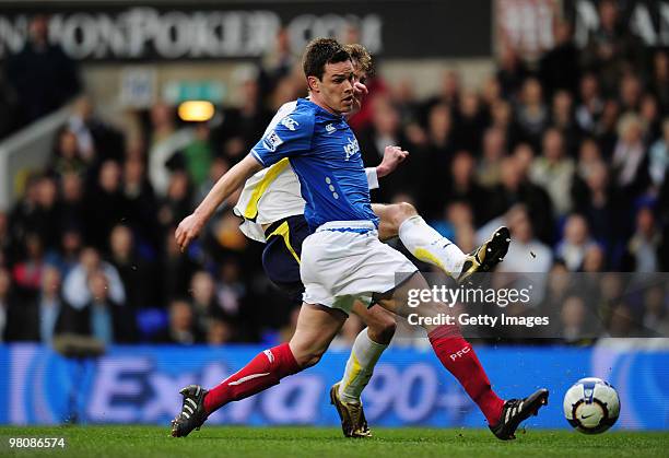 Peter Crouch of Tottenham Hotspur is challenged by Steve Finnan of Portsmouth during the Barclays Premier League match between Tottenham Hotspur and...