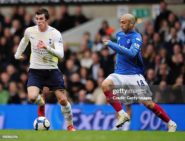 Gareth Bale of Tottenham Hotspur is challenged by Anthony Vanden Borre of Portsmouth during the Barclays Premier League match between Tottenham...