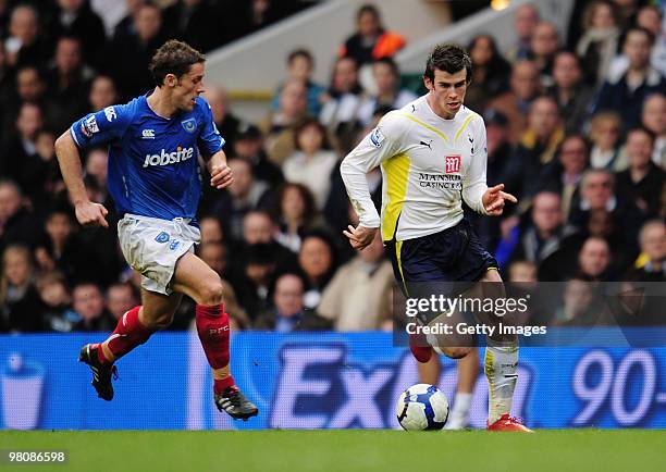 Gareth Bale of Tottenham Hotspur is challenged by Michael Brown of Portsmouth during the Barclays Premier League match between Tottenham Hotspur and...