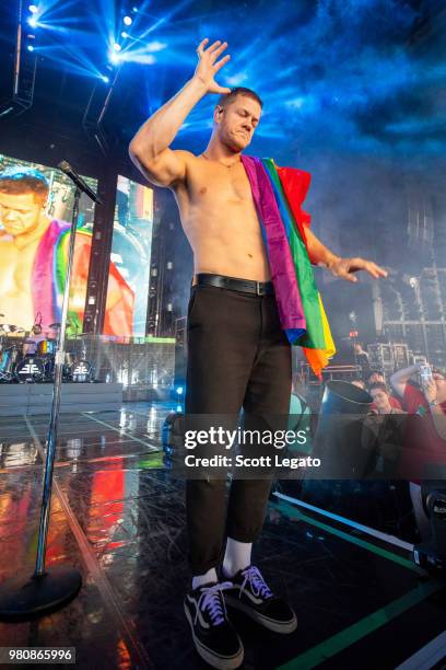 Dan Reynolds of Imagine Dragons holds a gay pride flag during their Evolve World Tour 2018 at DTE Energy Music Theater on June 21, 2018 in Clarkston,...