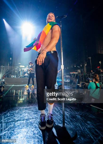 Dan Reynolds of Imagine Dragons holds a gay pride flag during their Evolve World Tour 2018 at DTE Energy Music Theater on June 21, 2018 in Clarkston,...
