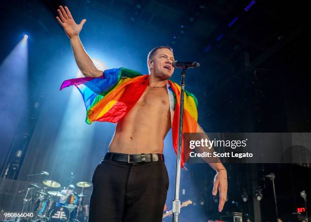 Dan Reynolds of Imagine Dragons holds a gay pride flag during their Evolve World Tour 2018 at DTE Energy Music Theater on June 21, 2018 in Clarkston,...