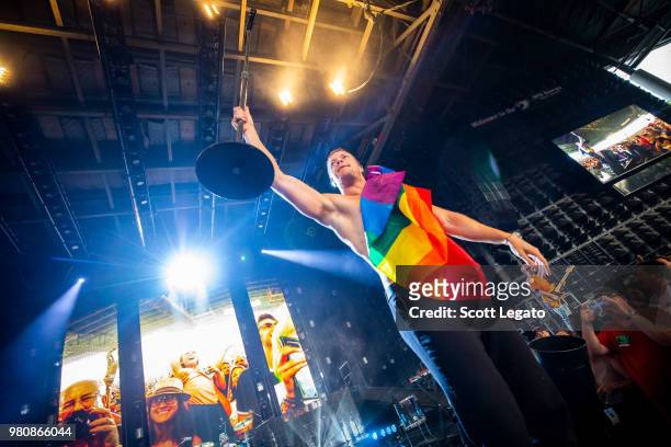Dan Reynolds of Imagine Dragons holds a gay pride flag during their Evolve World Tour 2018 at DTE Energy Music Theater on June 21, 2018 in Clarkston,...