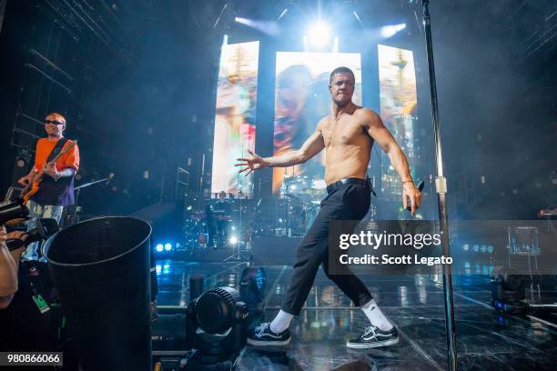 Ben McKee and Dan Reynolds of Imagine Dragons perform during their Evolve World Tour 2018 at DTE Energy Music Theater on June 21, 2018 in Clarkston,...