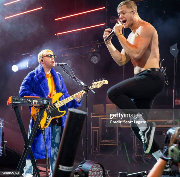 Ben McKee and Dan Reynolds of Imagine Dragons perform during their Evolve World Tour 2018 at DTE Energy Music Theater on June 21, 2018 in Clarkston,...