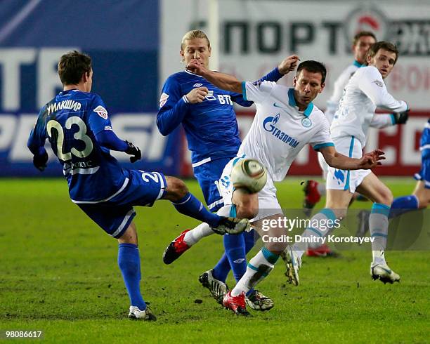 Luke Wilkshire of FC Dynamo Moscow battles for the ball with Konstantin Zyryanov of FC Zenit St. Petersburg during the Russian Football League...