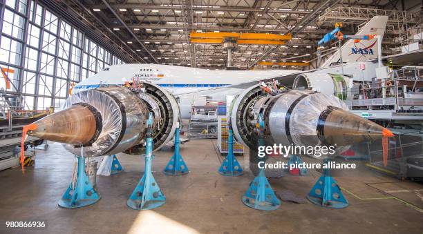 Dpatop - Two jet engines lie next to a stratospheric research aircraft inside a maintenance hangar in Hamburg, Germany, 19 March 2018. Lufthansa...