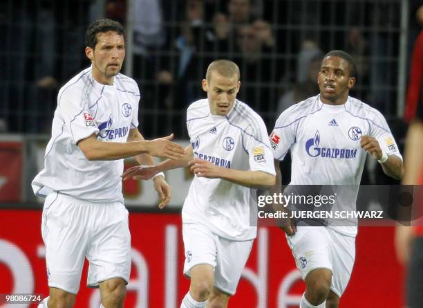 Schalke's striker Kevin Kuranyi celebrates scoring with Schalke's midfielder Peer Kluge and Schalke's Peruvian striker Jefferson Farfan during the...