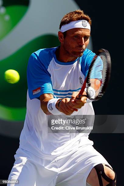 Mardy Fish of the United States returns a shot against Andy Murray of Great Britain during day five of the 2010 Sony Ericsson Open at Crandon Park...
