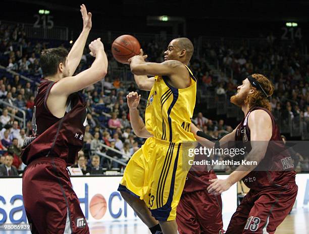 Immanuel McElroy of Berlin is attacked by Darren Fenn of Quakenbrueck and team mate Chad Prewitt during the Beko Basketball Bundesliga match between...