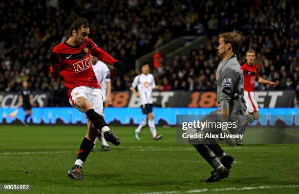 Dimitar Berbatov of Manchester United scores his team's second goal past Jussi Jaaskelainen of Bolton Wanderers during the Barclays Premier League...