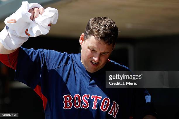 Pitcher John Lackey of the Boston Red Sox loosens up in the dugout against the Baltimore Orioles during a Grapefruit League Spring Training Game at...