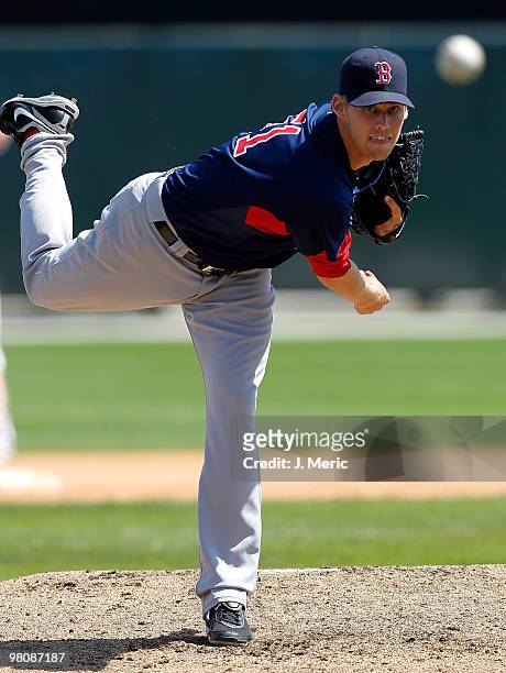Pitcher Daniel Bard of the Boston Red Sox loosens up in the dugout against the Baltimore Orioles during a Grapefruit League Spring Training Game at...