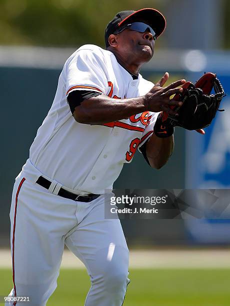 Infielder Miguel Tejada of the Baltimore Orioles catches a fly ball for an out against the Boston Red Sox during a Grapefruit League Spring Training...
