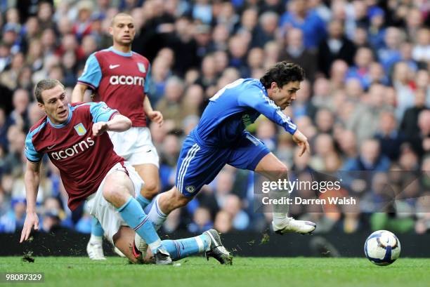 Richard Dunne of Aston Villa challenges Yury Zhirkov of Chelsea resulting in a penalty during the Barclays Premier League match between Chelsea and...