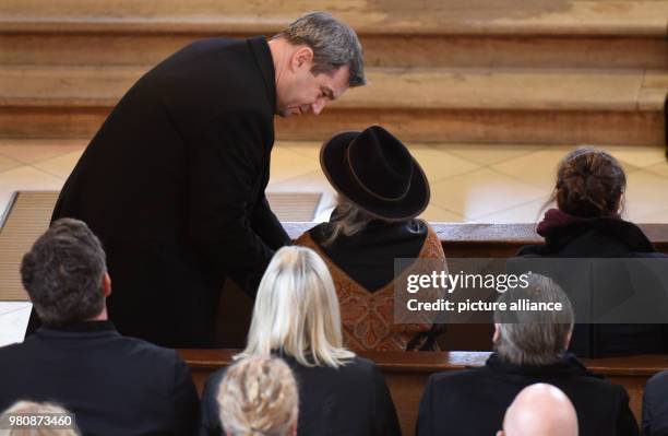 March 2018, Germany, Habach: The Bavarian Premier Markus Soeder of the Christian Social Union speaks to the widow Karin Rauch in the church during...