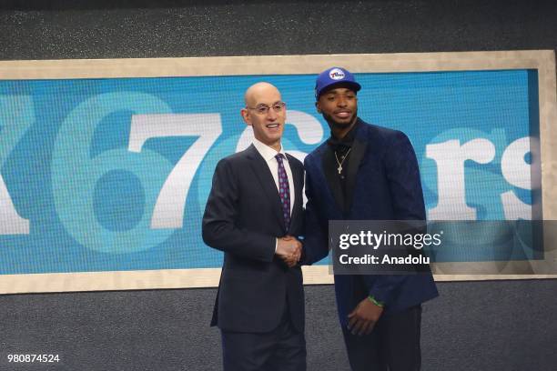 Mikal Bridges shakes hands with NBA Commissioner Adam Silver after being drafted tenth overall by the Philadelphia 76ers during the 2018 NBA Draft in...