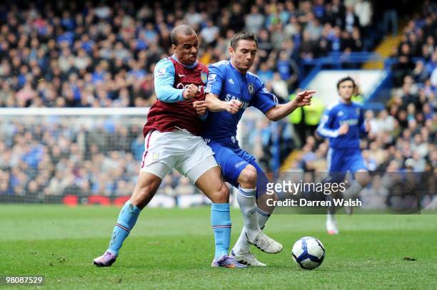 Frank Lampard of Chelsea challenges Gabriel Agbonlahor of Aston Villa during the Barclays Premier League match between Chelsea and Aston Villa at...
