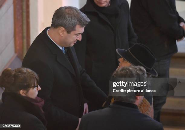 March 2018, Germany, Habach: The Bavarian Premier Markus Soeder of the Christian Social Union speaks to the widow Karin Rauch in the church during...