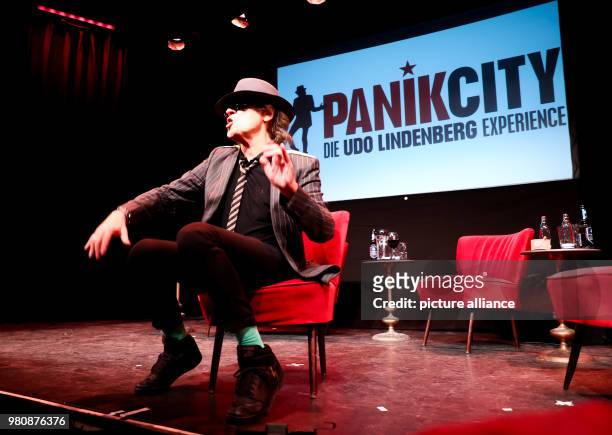 March 2018, Germany, Hamburg: Rockstar Udo Lindenberg sits on stage during the opening of the 'Panik City - The Udo-Lindenberg-Experience'. The...